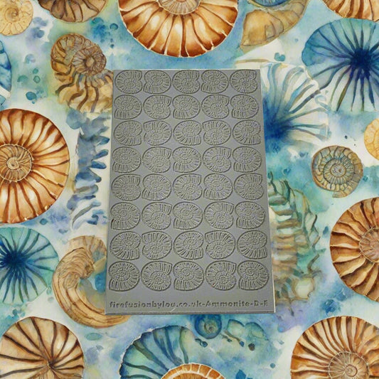 A 95 x 55 mm texture mat with debossed and embossed ammonite in a repeat pattern. Use to make a impression on metal clay and polymer clay.