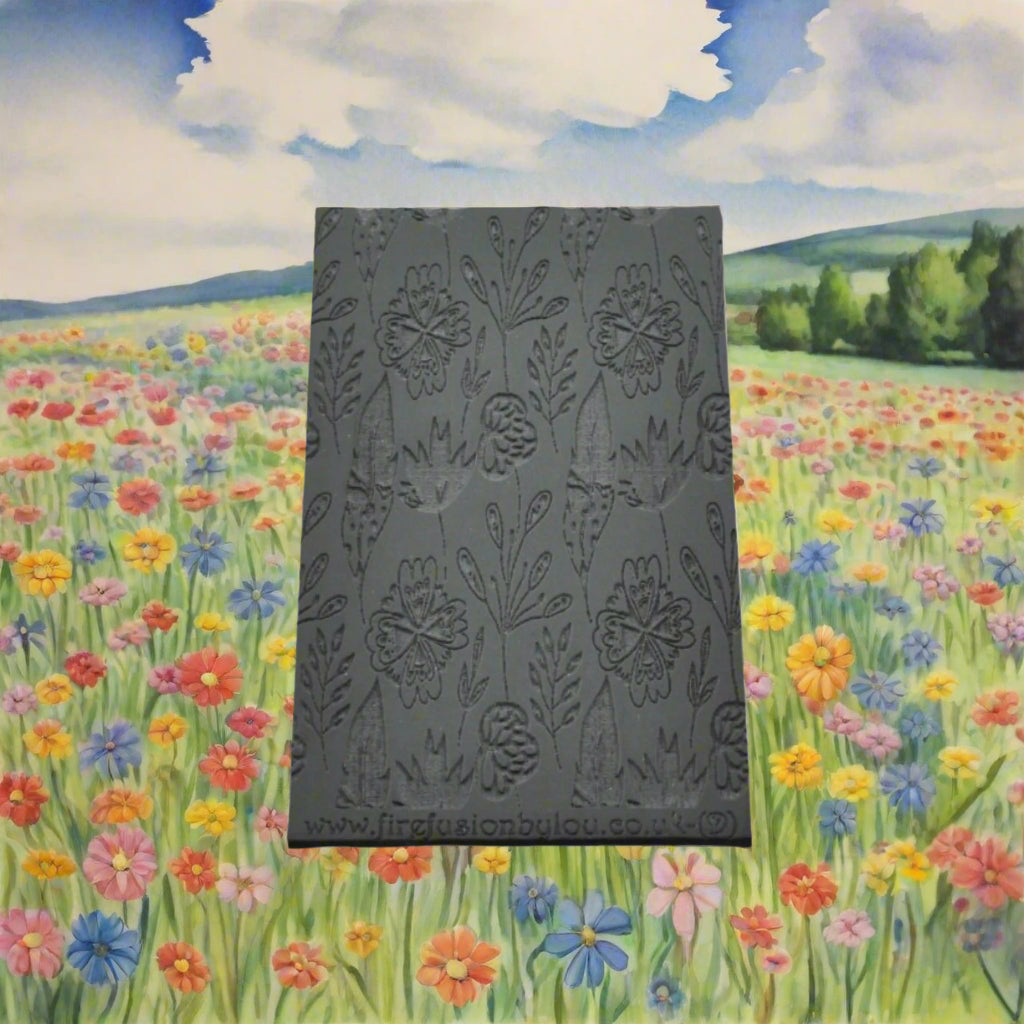 A 95 x 55 mm debossed texture mat with a flower design. Use to make a embossed impression on metal clay and polymer clay.
