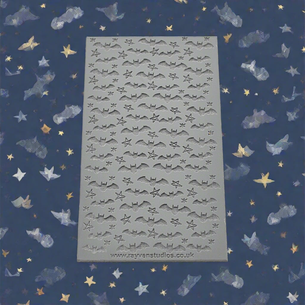 A texture mat of bats and stars debossed.  Will have an embossed design on metal clay or polymer.