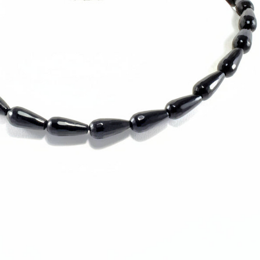 Black beaded necklace on a white background