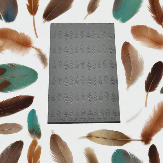 A feather pattern debossed texture mat in grey material. This texture mat will give you an embossed effect on metal clay or polymer clay.