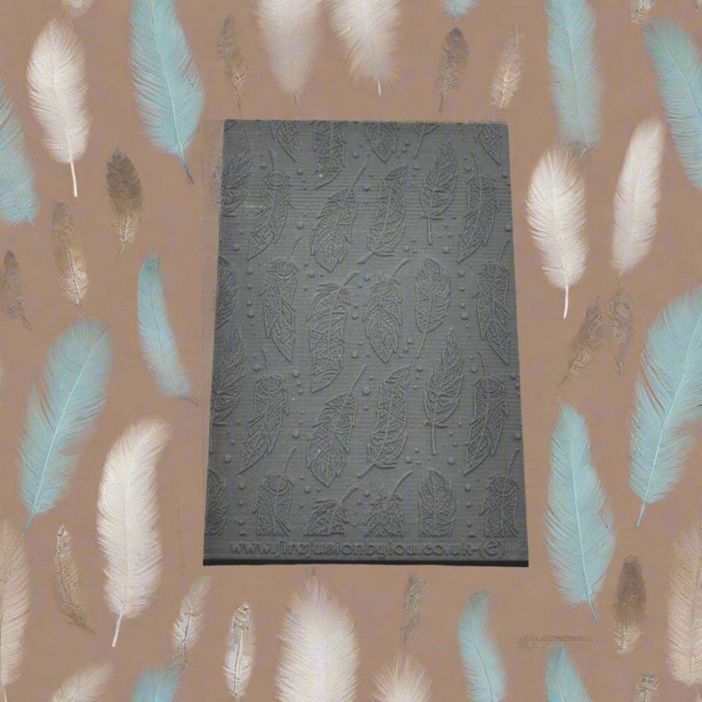 A feather pattern embossed texture mat in grey material. This texture mat will give you an embossed effect on metal clay or polymer clay.