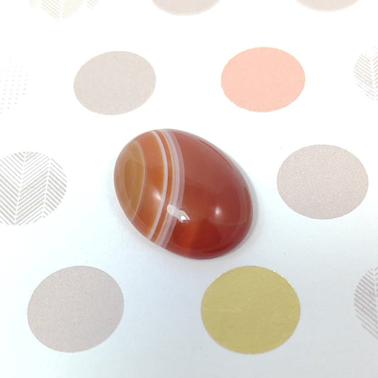 Polished agate stone on a patterned background
