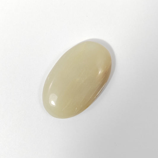 Beige oval stone on a white background
