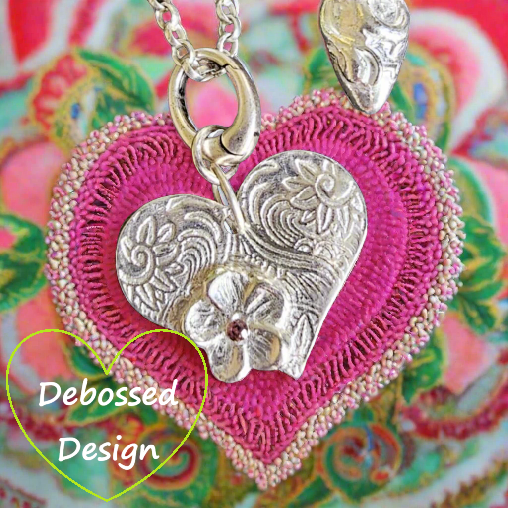 A texture embossed in metal silver clay Using a Celtic heart debossed texture mat after firing. This will give you an idea of what it will look like on metal clay.