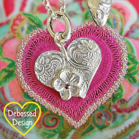 A texture embossed in metal silver clay Using a Celtic heart debossed texture mat after firing. This will give you an idea of what it will look like on metal clay.