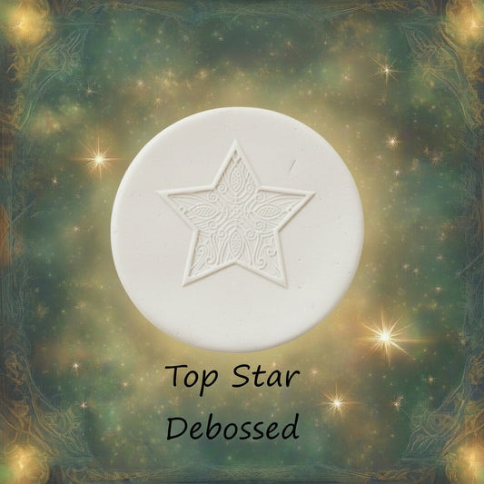 A Celtic star pattern embossed in silly putty Using a debossed texture mat in grey material. This will give you an idea of what it will look like on metal clay or polymer clay.