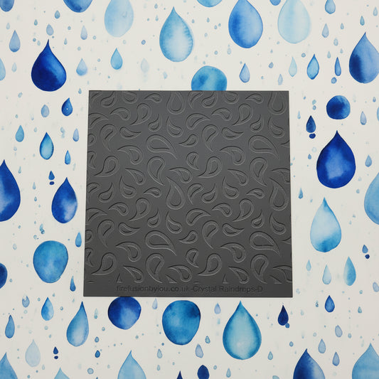 A raindrop pattern debossed texture mat in grey material. This texture mat will give you an embossed effect on metal clay or polymer clay.