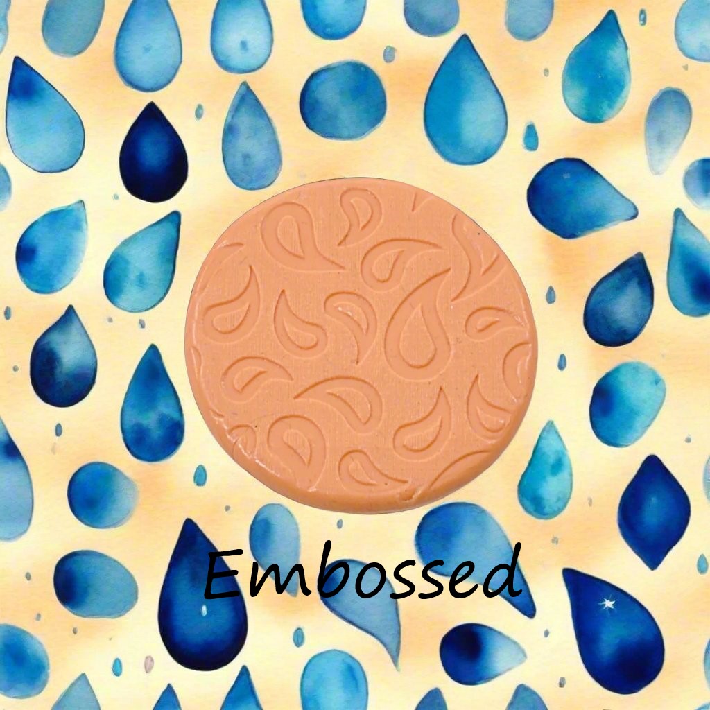 A raindrop pattern debossed in silly putty Using a patterned embossed texture mat in grey material. This will give you an idea of what it will look like on metal clay or polymer clay.
