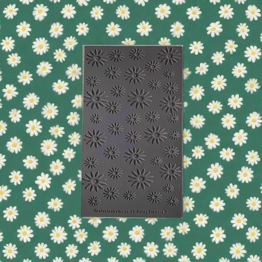 texture mat with a debossed daisy repeat pattern. Use to make a impression on metal clay and polymer clay.