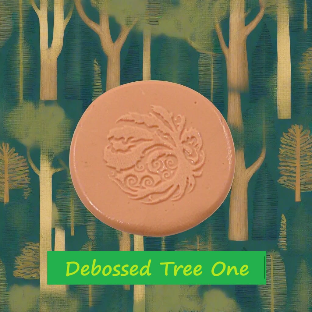 A tree embossed in silly putty Using a debossed texture mat in grey material. This will give you an idea of what it will look like on metal clay or polymer clay.