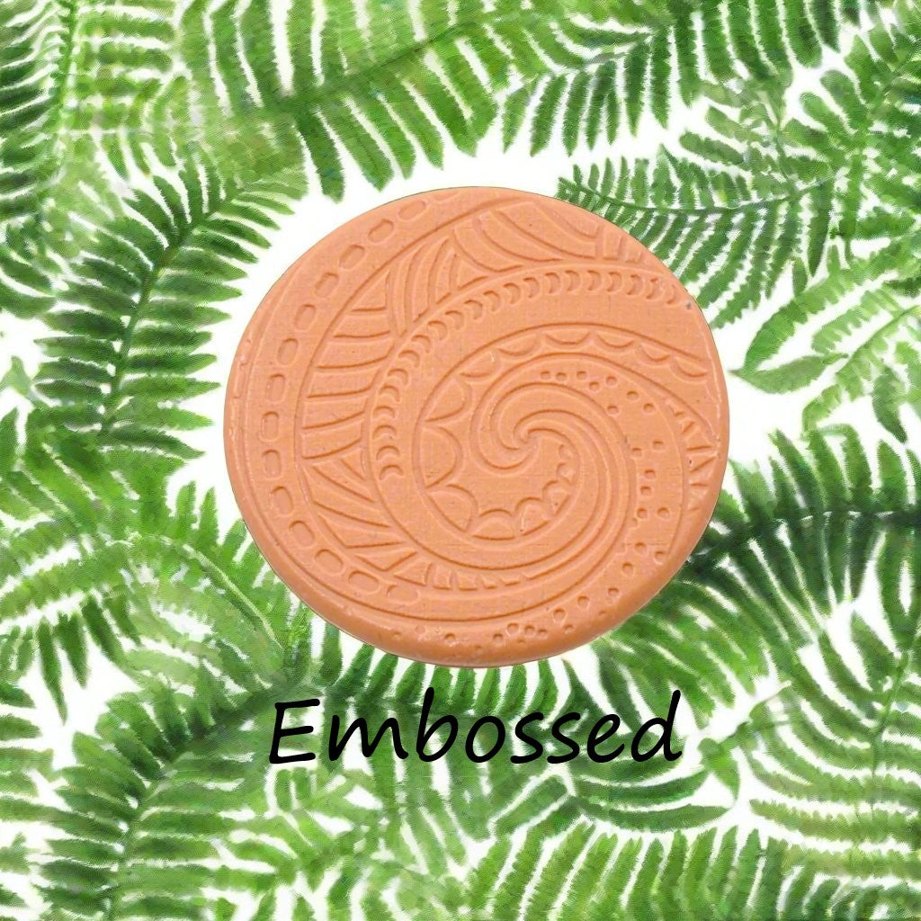 A pattern debossed in silly putty Using a patterned embossed texture mat in grey material. This will give you an idea of what it will look like on metal clay or polymer clay.