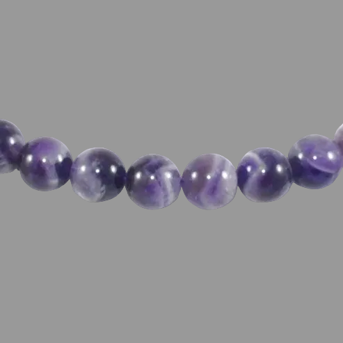 Close-up of a string of purple beads on a gray background