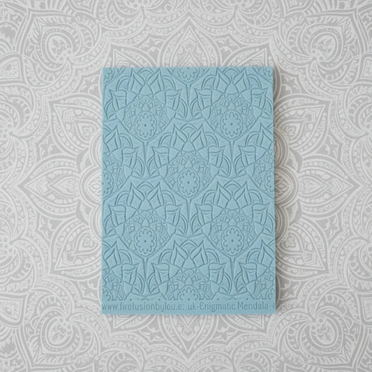 A debossed texture mat with a lacey flowery mandala design. Use to make an impression on metal clay and polymer clay.
