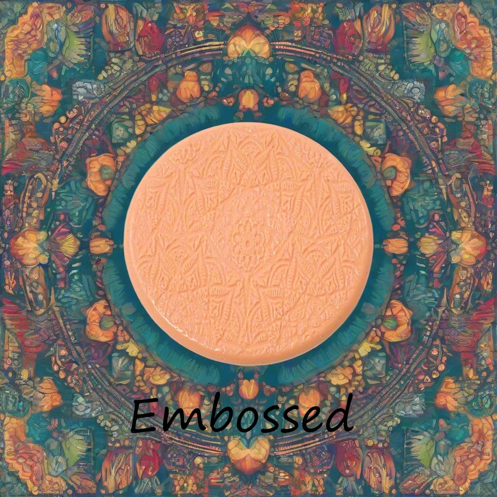 A lacey flowery mandala pattern debossed in silly putty Using a embossed texture mat in grey material. This will give you an idea of what it will look like on metal clay or polymer clay.