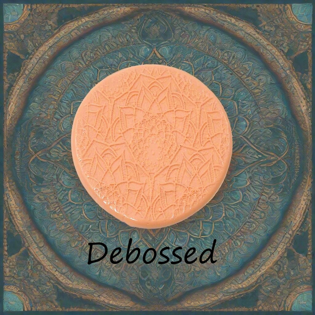 A lacey flowery mandala pattern embossed in silly putty Using a debossed texture mat in grey material. This will give you an idea of what it will look like on metal clay or polymer clay.