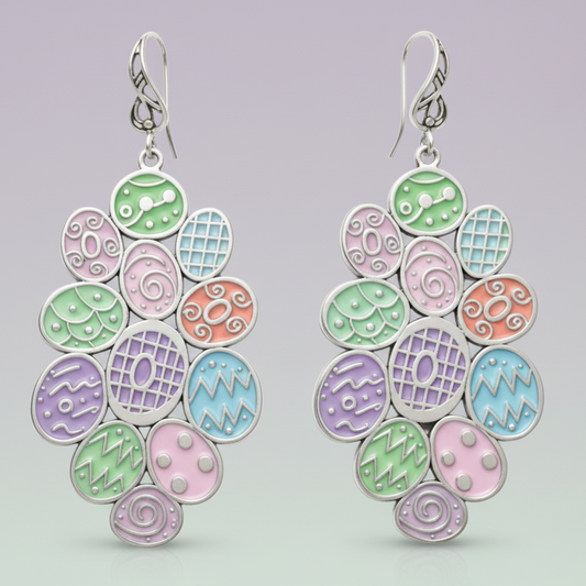 Pair of colourful earrings with oval designs on a white background