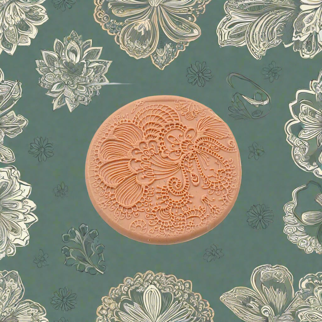 A floral pattern embossed in silly putty Using a debossed texture mat. This will give you an idea of what it will look like on metal clay or polymer clay.