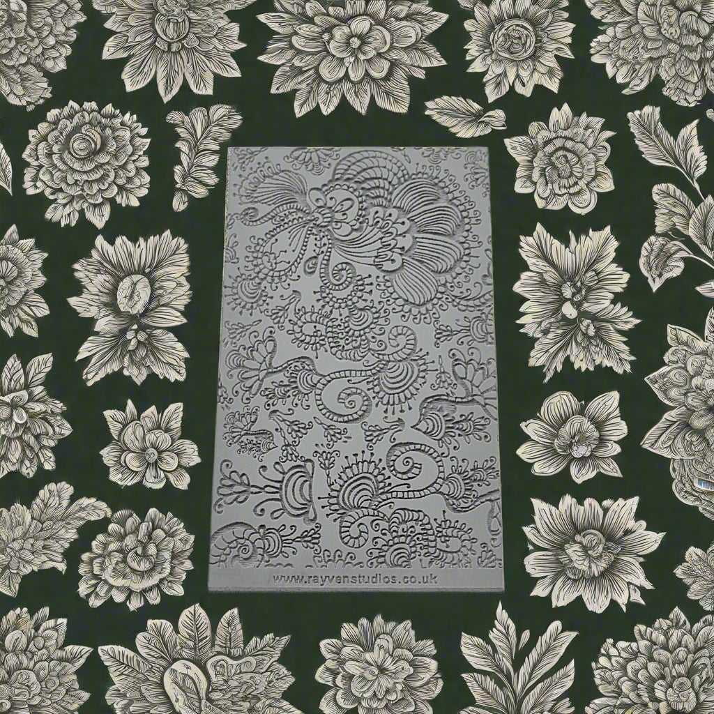 A texture mat of intricate florals debossed. Will have an embossed design on metal clay or polymer.