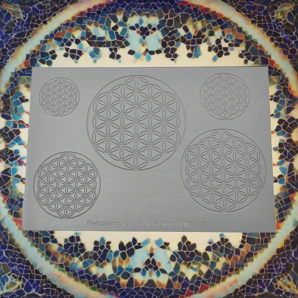 A debossed texture mat with a geometric flower of life repeat design. Use to make an embossed impression on metal clay and polymer clay