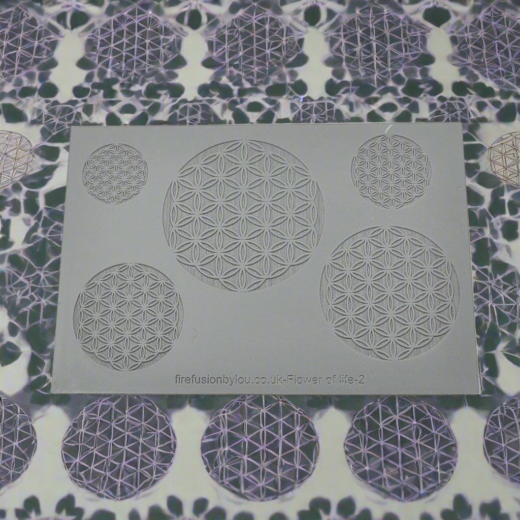 An embossed texture mat with a geometric flower of life repeat design. Use to make a debossed impression on metal clay and polymer clay
