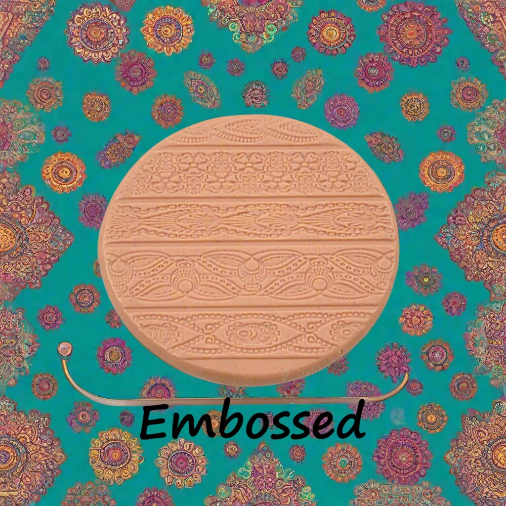 A pattern debossed in silly putty Using an Indian henna embossed texture mat in grey material. This will give you an idea of what it will look like on metal clay or polymer clay.