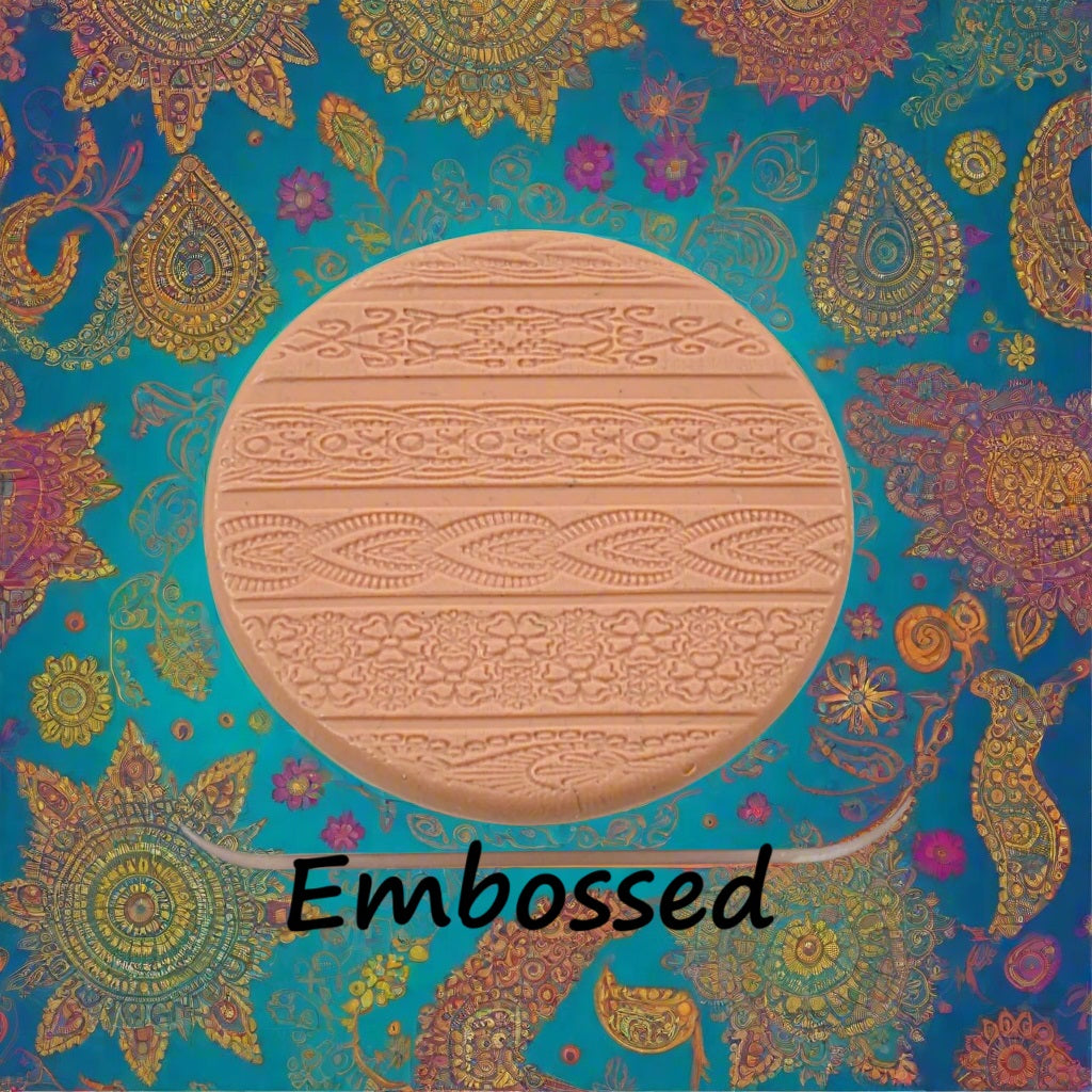 A pattern debossed in silly putty Using an Indian henna embossed texture mat in grey material. This will give you an idea of what it will look like on metal clay or polymer clay.