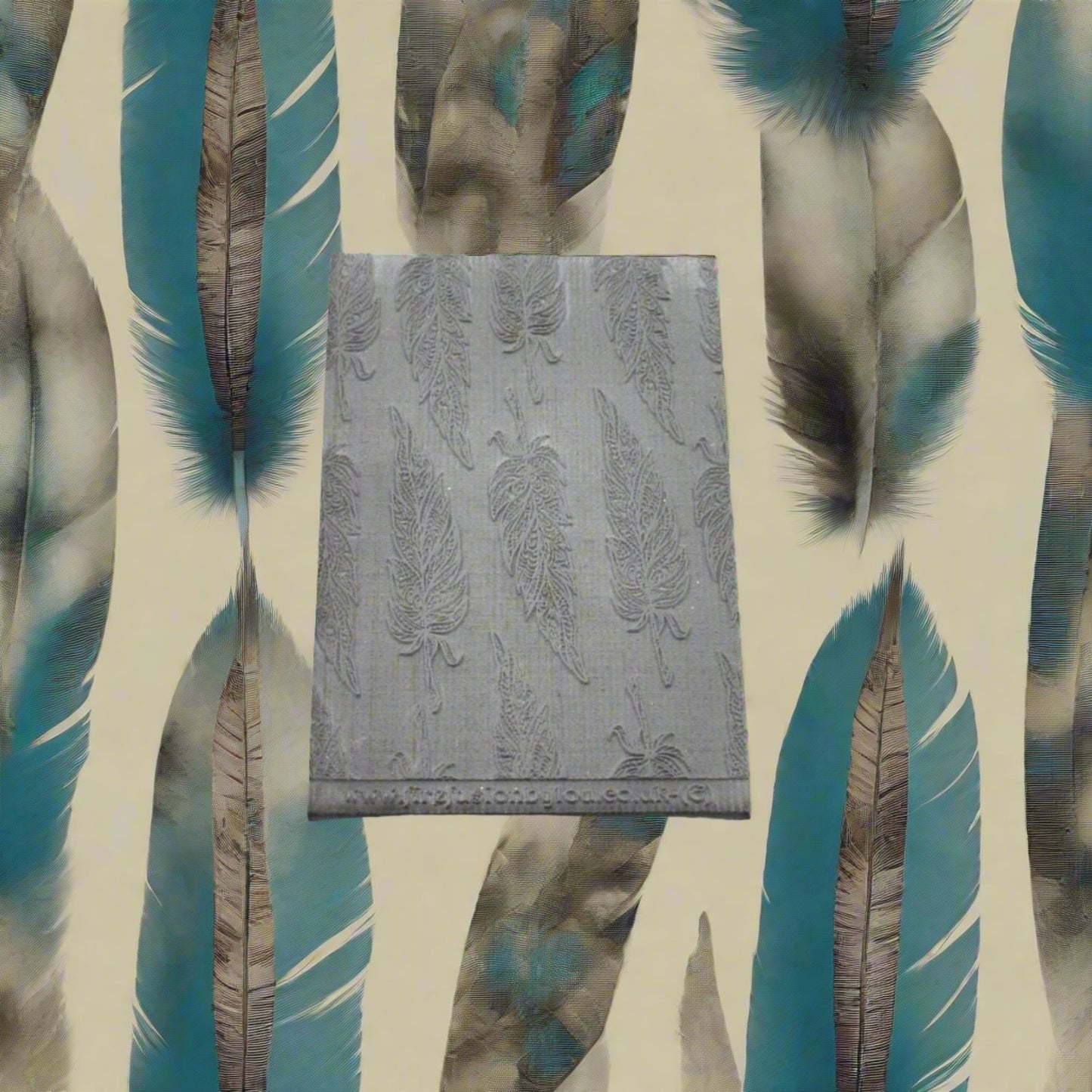A tribal feather pattern embossed texture mat in grey material. This texture mat will give you an embossed effect on metal clay or polymer clay.