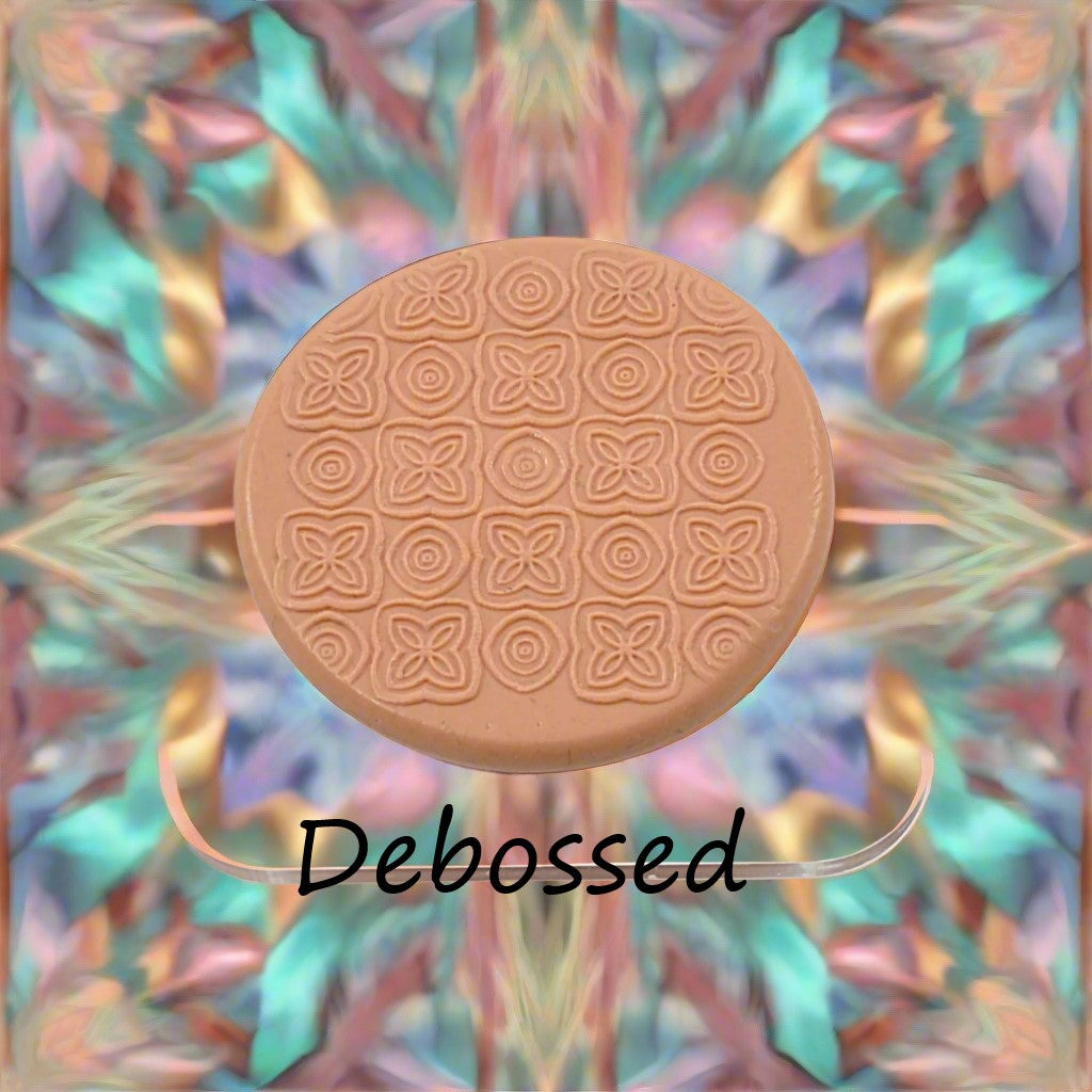 A pattern embossed in silly putty Using a patterned debossed texture mat in grey material. This will give you an idea of what it will look like on metal clay or polymer clay.