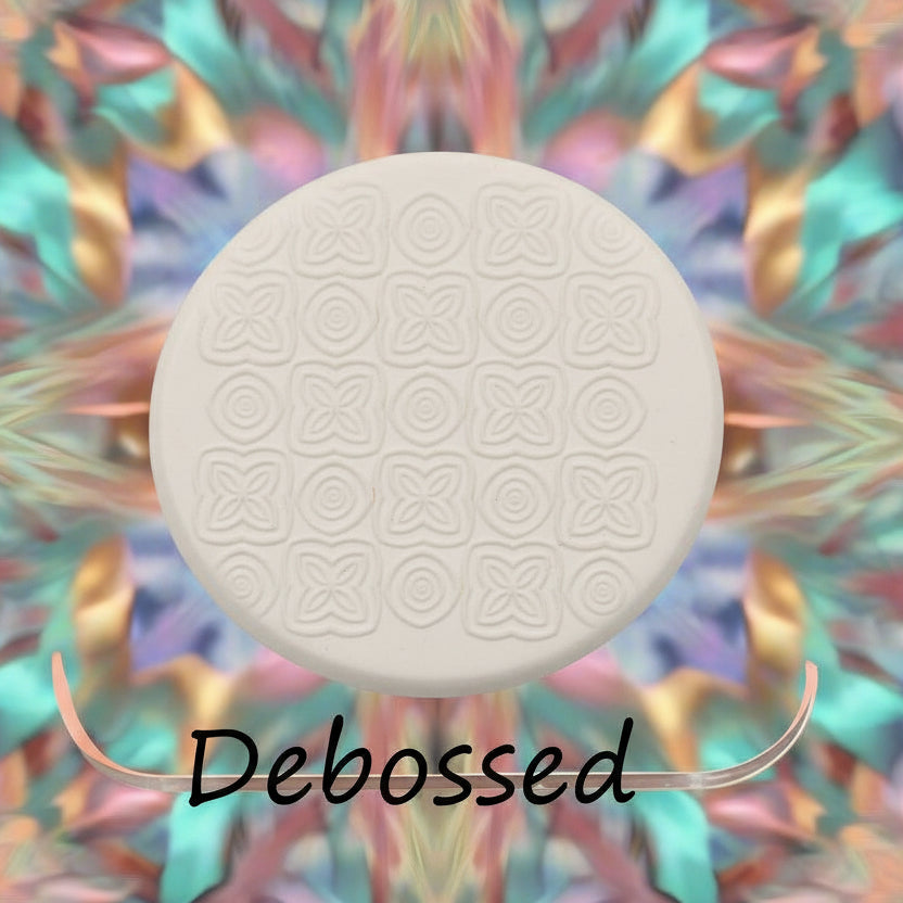 A pattern embossed in silly putty Using a patterned debossed texture mat in grey material. This will give you an idea of what it will look like on metal clay or polymer clay.