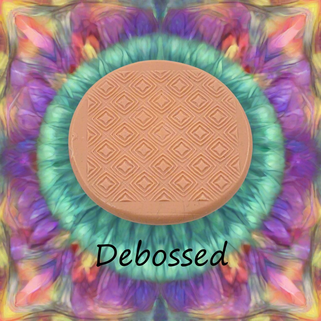 A pattern embossed in silly putty Using a patterned debossed texture mat in grey material. This will give you an idea of what it will look like on metal clay or polymer clay.