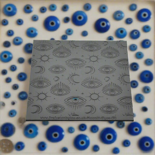 A mystical eye repeat pattern debossed texture mat in grey material. For use on metal clay or polymer clay.