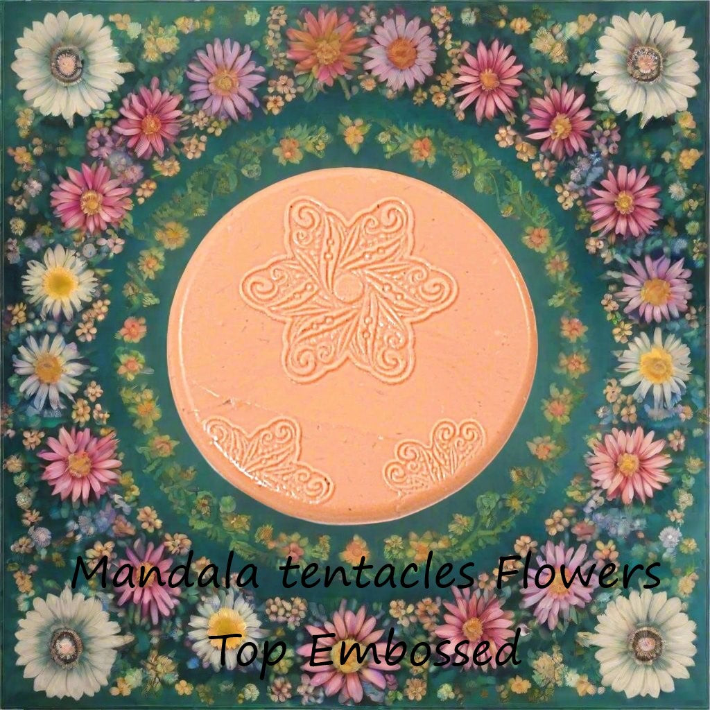 A flower mandala debossed in silly putty Using a embossed texture mat. This will give you an idea of what it will look like on metal clay or polymer clay.