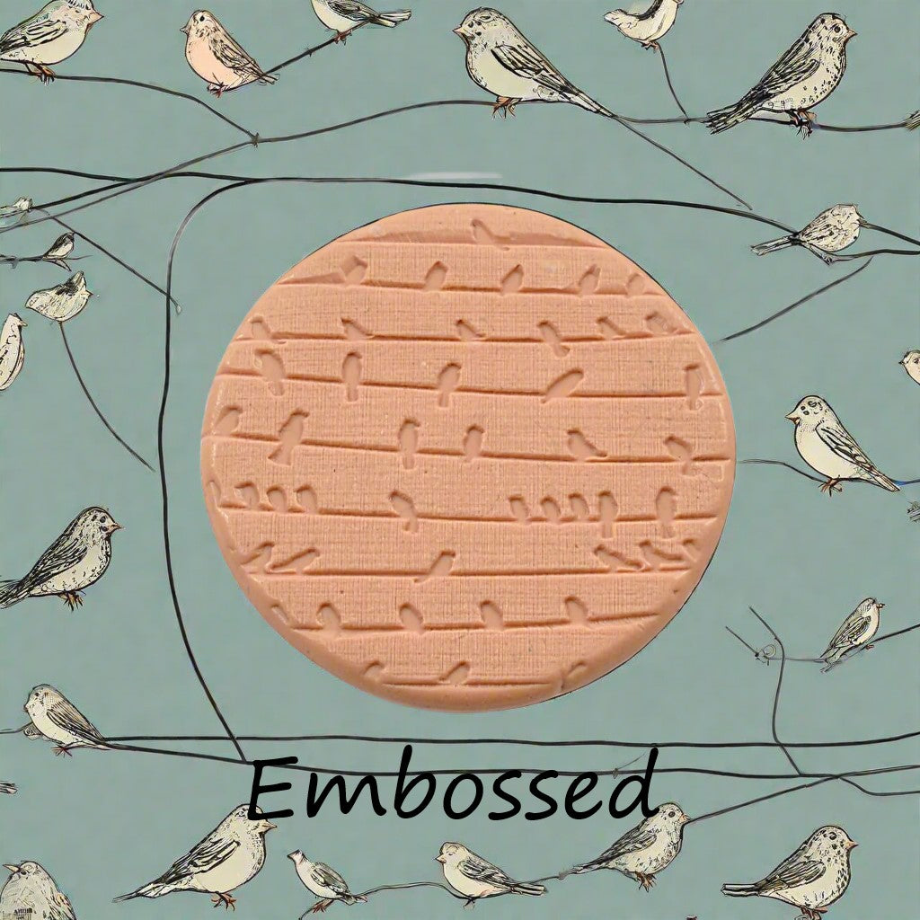 A reduced texture mat of birds on a wire debossed in silly putty Using a embossed texture mat. This will give you an idea of what it will look like on metal clay or polymer clay.