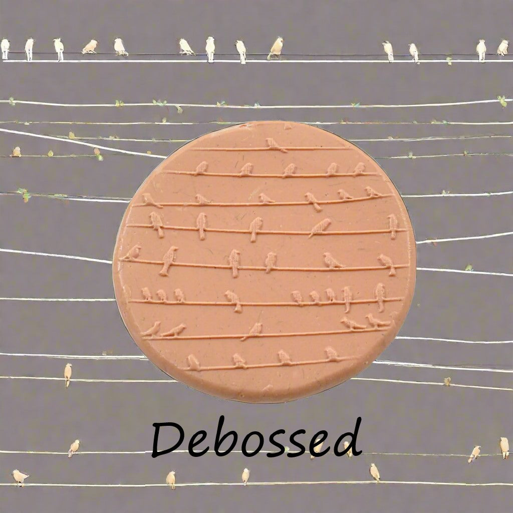 A reduced texture mat of birds on a wire embossed in silly putty Using a debossed texture mat. This will give you an idea of what it will look like on metal clay or polymer clay.