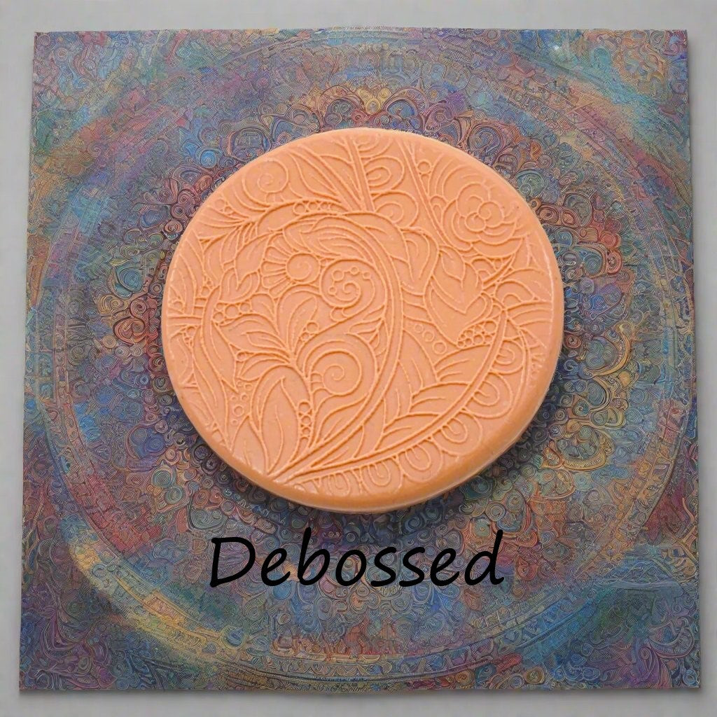 A flowery design embossed in silly putty using a debossed texture mat. This will give you an idea of what it will look like on metal clay or polymer clay.