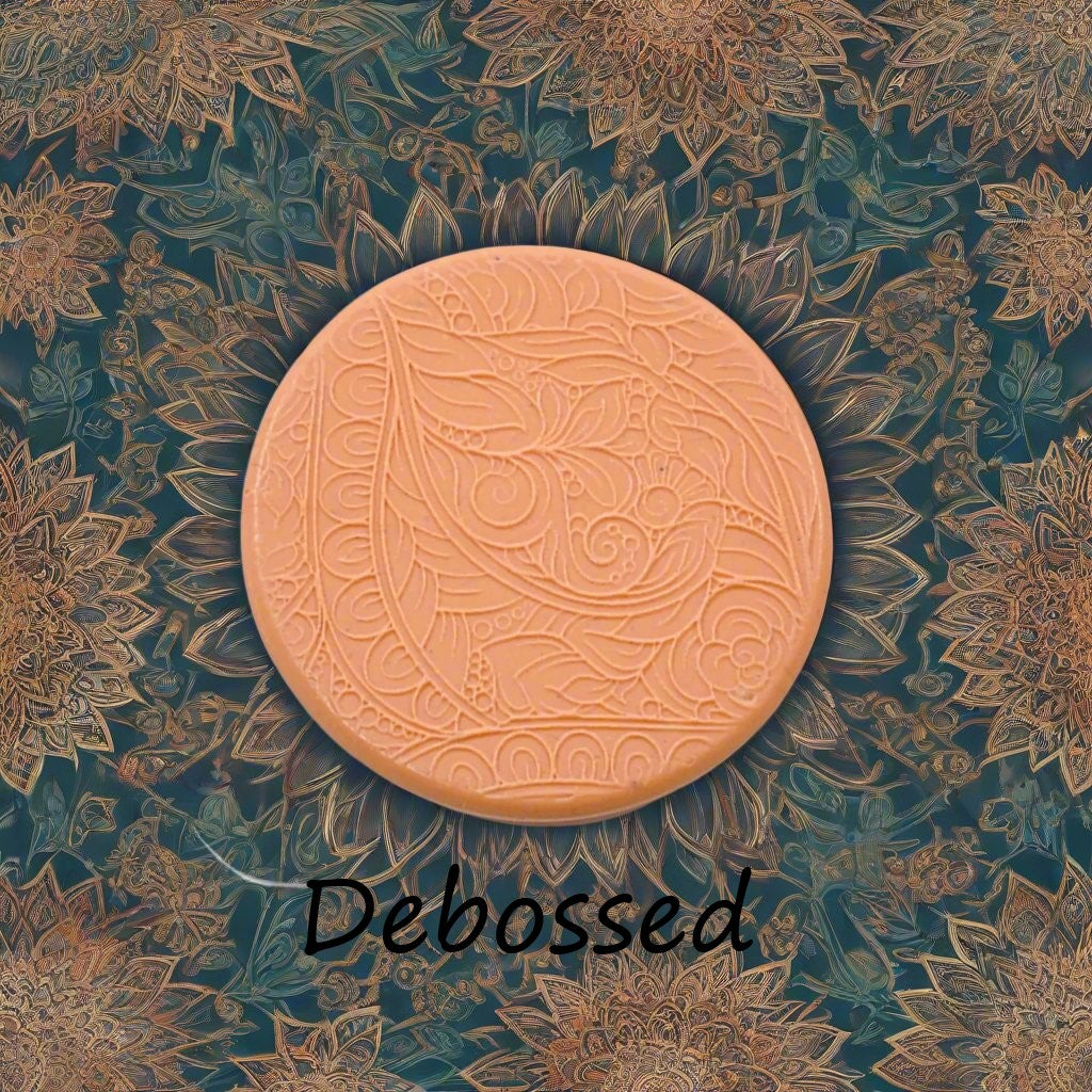 A flowery design embossed in silly putty Using a debossed texture mat. This will give you an idea of what it will look like on metal clay or polymer clay.