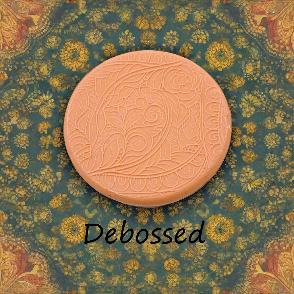 A flowery design embossed in silly putty Using a debossed texture mat. This will give you an idea of what it will look like on metal clay or polymer clay.