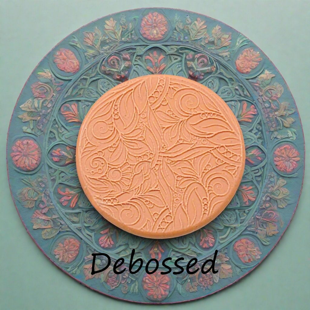 A flowery design embossed in silly putty using a debossed texture mat. This will give you an idea of what it will look like on metal clay or polymer clay.
