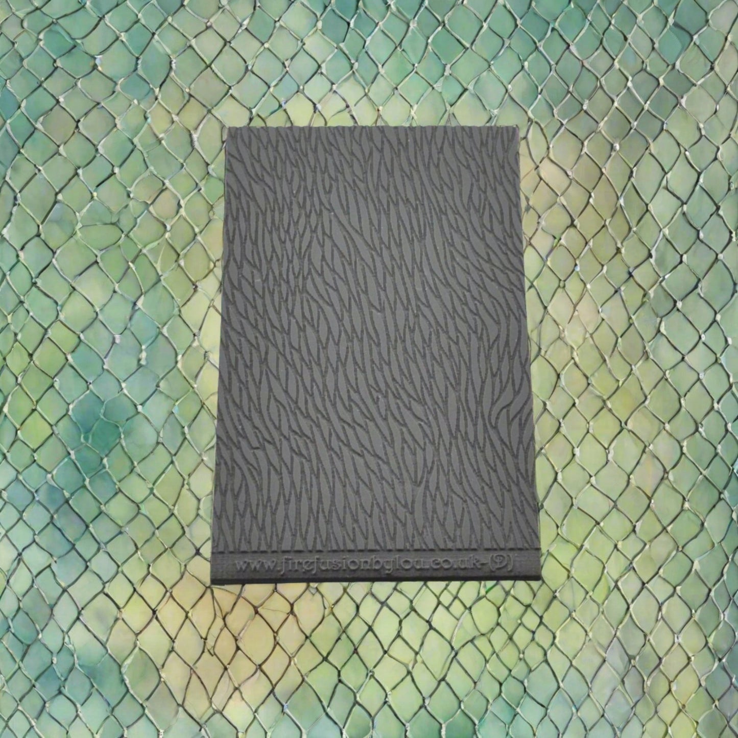 A pattern debossed texture mat in grey material, size 95mm x 55mm. This texture mat will give you an embossed effect on metal clay or polymer clay.