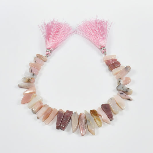 Pink opal teeth ranging from 30 x 12 mm to 27 by 5 mm 8.5 inch strand