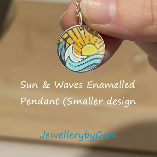 Sun and waves enamelled pendant held by a hand with 'JewellerybyGem' branding.