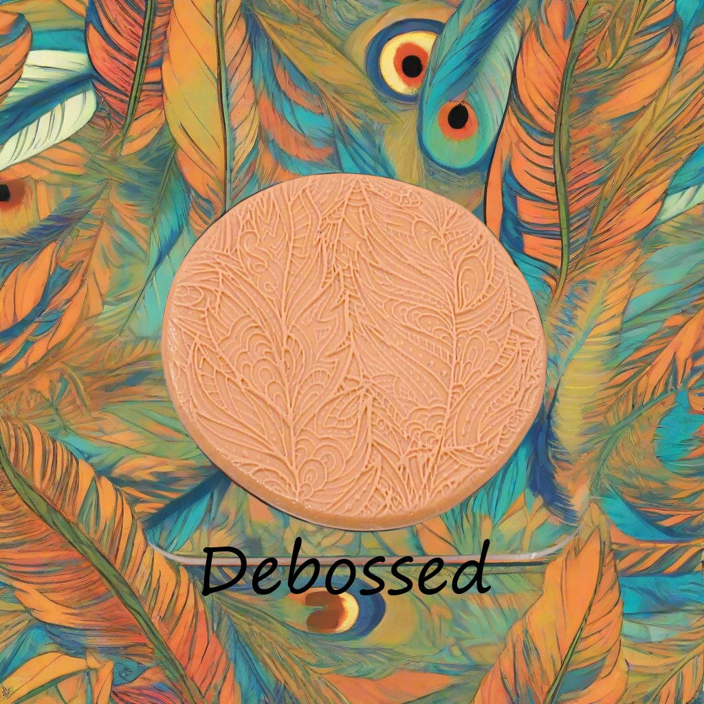A tribal psychedelic feather pattern debossed in silly putty Using a patterned embossed texture mat in grey material. This will give you an idea of what it will look like on metal clay or polymer clay.