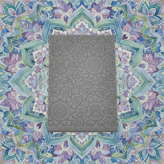 A debossed texture mat with a flowery mandala design. Use to make an impression on metal clay and polymer clay.