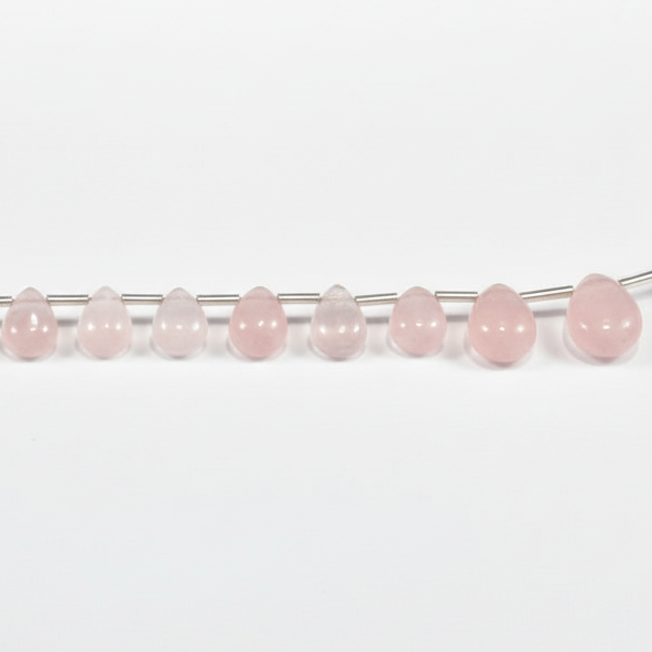 Row of pink beads on a string against a white background