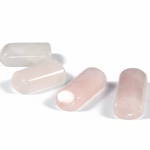 Four pink rose quartz close up on a white background