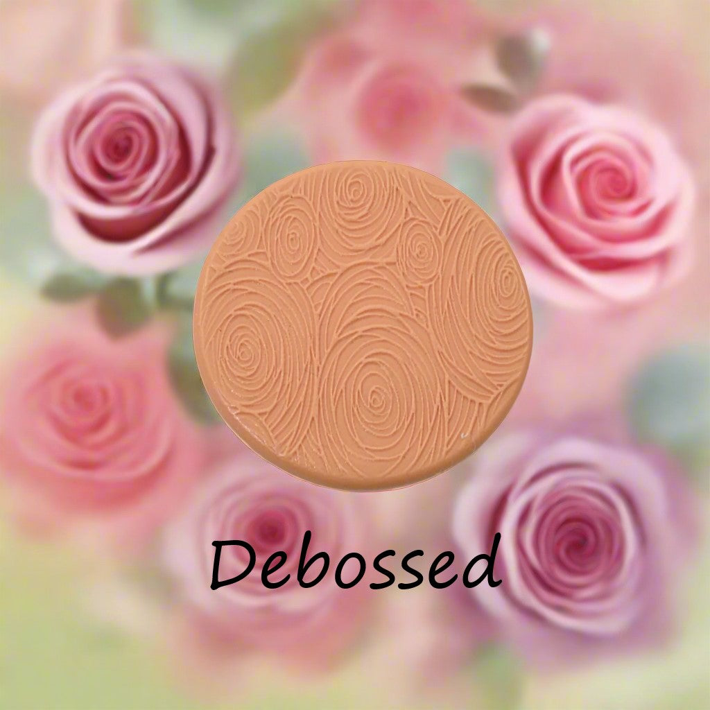 A rose pattern embossed in silly putty Using a small sunflower patterned debossed texture mat in grey material. This will give you an idea of what it will look like on metal clay or polymer clay.