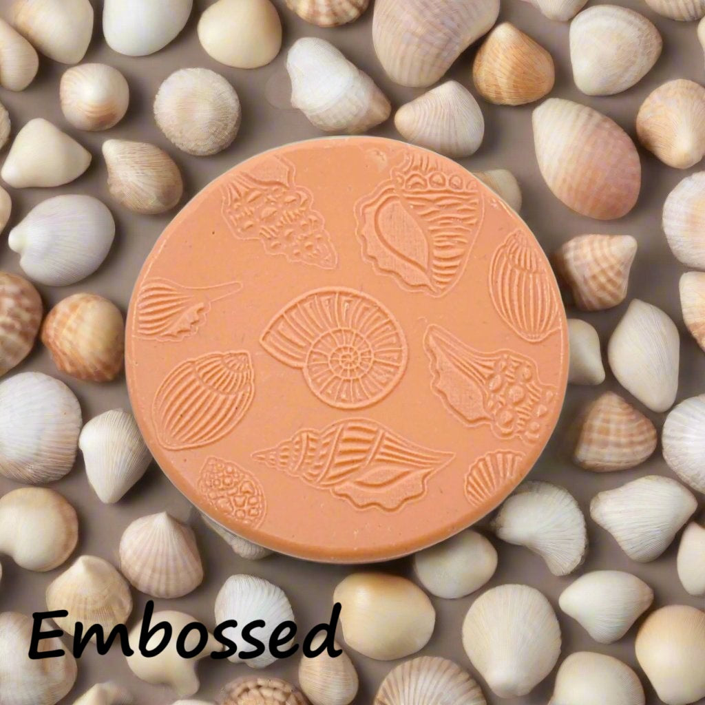 Seashells debossed in silly putty Using an embossed texture mat in grey material. This will give you an idea of what it will look like on metal clay or