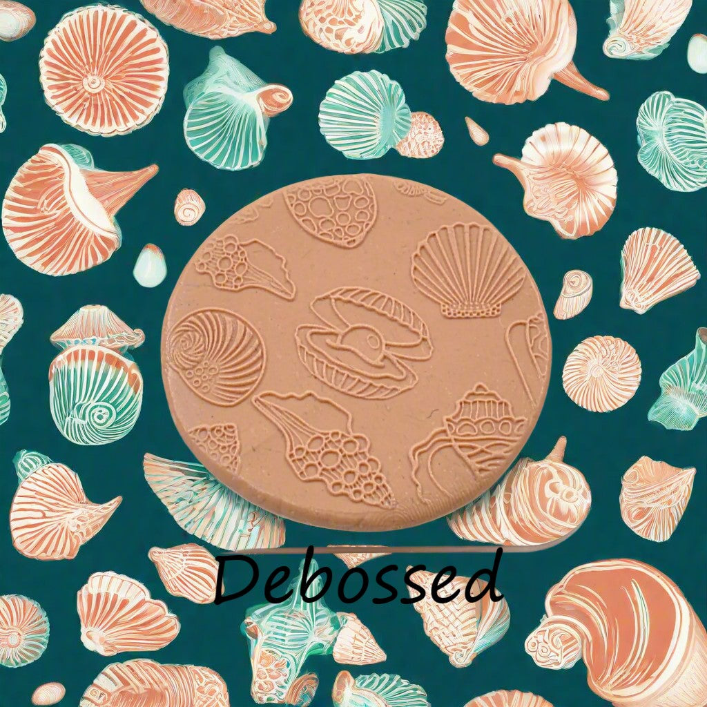 Seashells embossed in silly putty Using a debossed texture mat in grey material. This will give you an idea of what it will look like on metal clay or polymer clay.