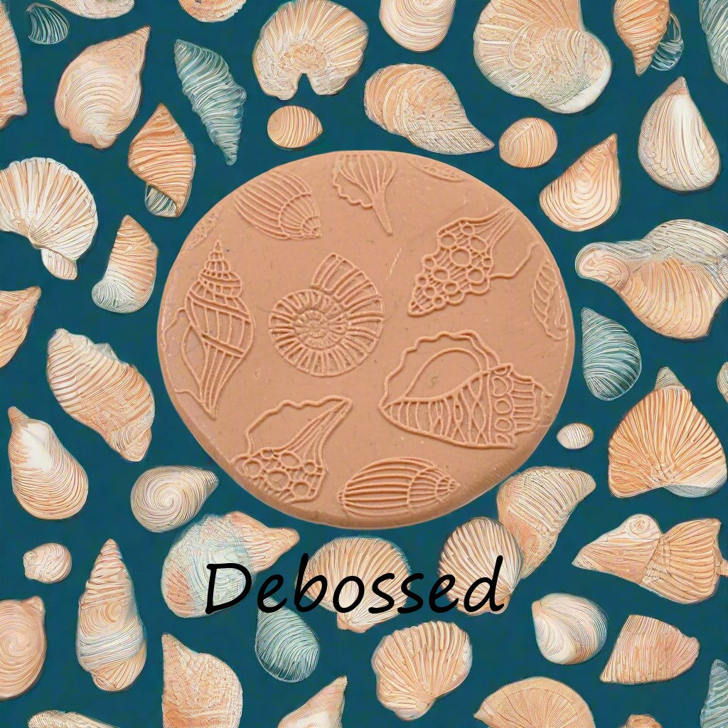 Seashells embossed in silly putty Using a debossed texture mat in grey material. This will give you an idea of what it will look like on metal clay or polymer clay.
